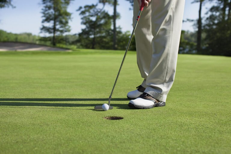 Golfer tapping in a putt